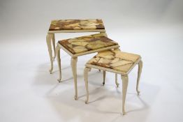 A French white painted metal nest of three tables with marble tops,