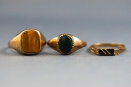 A selection of three signet rings consisting of a tigers eye, bloodstone and rectangular onyx.