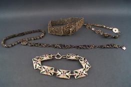 A selection of five silver bracelets consisting of a filigree panel bracelet,