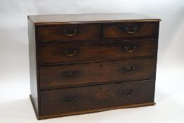 A George III mahogany chest of two short of three long drawers, feet missing,