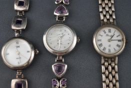 A selection of three silver dress watches to include two with purple gem set bracelets and one with