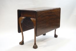 A 19th century mahogany drop leaf table on cabriole legs with ball and claw feet,