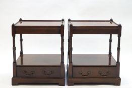 A pair of reproduction mahogany two tier side tables with drawers,