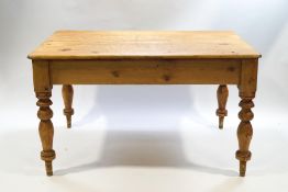 A Victorian and later pine kitchen table on turned legs,
