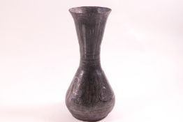 An Eastern steel vase of wasted form, with crosshatch and scroll decoration,