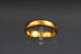 A 22ct gold wedding ring. 4.5mm Size N (approximate) Hallmarked 22ct, Birmingham, 1924 5.