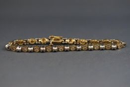 A 14ct yellow and white gold diamond bracelet approximately 1ct.