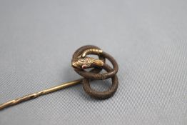A Victorian hair snake hat pin. Tests indicate 15ct gold. 4.