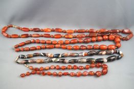 A collection of strung graduated beaded necklaces consisting of Agate and other materials.