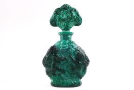 A Czech malachite glass scent bottle and stopper, each side decorated with cavorting cherubs,