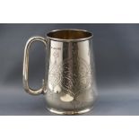 A Victorian silver tankard, engraved with stylised panels flanking two vacant cartouches, 11.