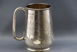A Victorian silver tankard, engraved with stylised panels flanking two vacant cartouches, 11.