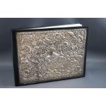 A silver mounted leather bound address book, the cover embossed with flowers, C scrolls,