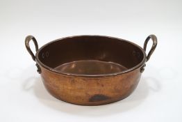 A large two handled kitchen copper pan,