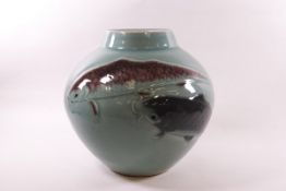A 20th century Japanese earthenware pot, decorated with Koi carp against a celadon ground,