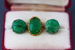 A yellow gold single stone ring set with oval cabochon jadeite. Tests indicate 22ct gold. Size M.