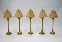 A set of five 20th century gilt metal table lamps, each with flared palm leaf tops,