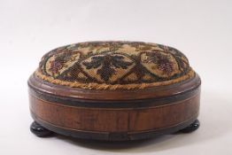 A Victorian circular mahogany footstool with beaded top,