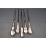 Five silver handled button hooks, comprising; a plain exampled with a shaped wavy handle,