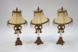 A set of three late 20th century table lamps of Classical form with silk shades,