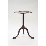 A mahogany occasional table, the pie crust top on fluted pedestal with tripod scroll legs, 58.