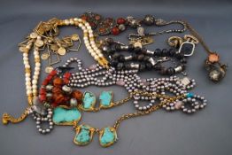 A quantity of costume jewellery to include a turquoise and gilt-wirework abstract-panel necklace,