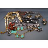 A quantity of costume jewellery to include a turquoise and gilt-wirework abstract-panel necklace,