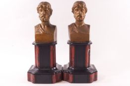 A pair of Spelter busts of Greek figures on black and red marble shaped bases,