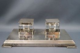 A rectangular silver inkstand, with two square glass inkwells, each with silver mounts,