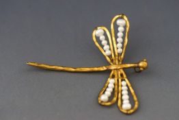 A gilt metal and cultured-freshwater pearl pendant in the form of a dragonfly, approx.