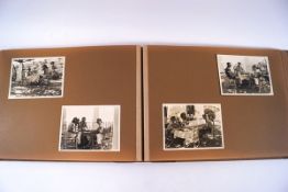 A pair of brown albums containing approximately 161, 9 x 7 and smaller snap shots.