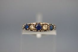 A graduated blue and white paste five stone carved half-hoop ring in late Victorian style,