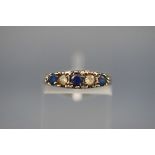 A graduated blue and white paste five stone carved half-hoop ring in late Victorian style,