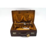 A Victorian leather dressing case containing four silver mounted bottles, the case monogrammed L.M.