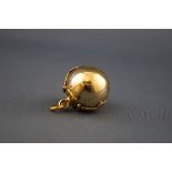 An early 20th century gold-plated 'Masonic ball' pendant with gothic trefoil terminated straps and