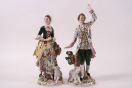 A pair of 20th century Sitzendorf porcelain figures of a lady and her companion with sheep at their
