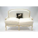 A 20th century French style two seater sofa, painted cream, 96cm high x 137cm wide,