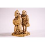 An early 20th century Japanese carving of two male figures, signature to base,