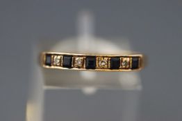 A modern 9ct gold, sapphire and diamond nine stone half-eternity ring, London 1983, size Q+, 1.