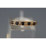 A modern 9ct gold, sapphire and diamond nine stone half-eternity ring, London 1983, size Q+, 1.