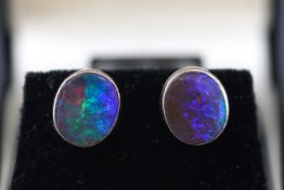 A pair of black opal oval single stone stud earrings,