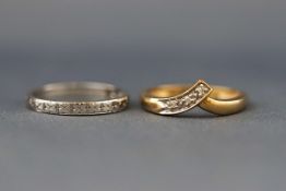 Two rings, comprising; a vintage small diamond three stone band ring, set in white stamped ‘18ct’,