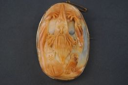 A cameo brooch depicting a wizard, a cat and an owl,