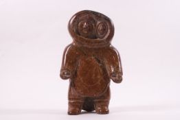 An Inuit carved stone figure of mother and child in standing pose,