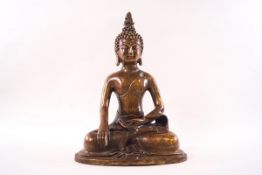 A polished bronze figure of a Buddha with legs crossed in the lotus position, 28.