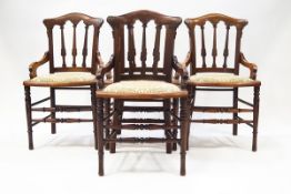 A set of four Victorian Arts & Crafts mahogany dining chairs with carved scroll detail,