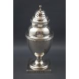 A George III silver vase shaped sugar caster on a square base with reeded borders and domed cover