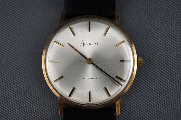 A 9ct yellow gold cased Accurist wristwatch having a circular silver baton dial.