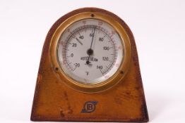 A Bentley car temperature gauge, mounted in a wooden and leather surround,