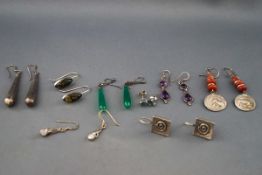 Eight pairs of silver and white metal earrings, some gem-set,